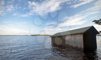 Small wooden boat garage on the coast of Saimaa lake, typically construction for Finland