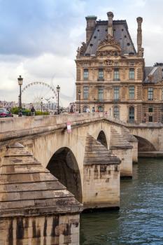 PARIS, FRANCE - AUGUST 07, 2014: The New Bridge over Seine river with Louvre museum facade on other side