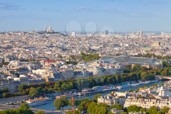 Birds eye view from Eiffel Tower on Paris city, France with Sacre Coeur cathedral on the horizon