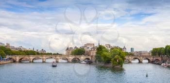 Panoramic rhoto of Cite Island and Pont Neuf, the oldest stone bridge across the Seine river in Paris, France