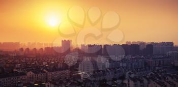 Bright colorful sunrise over big city panorama. Vintage toned photo with filter effect