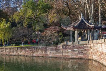 Hangzhou, China - December 5, 2014: traditional Chinese gazebo on the coast in famous West Lake park in Hangzhou city