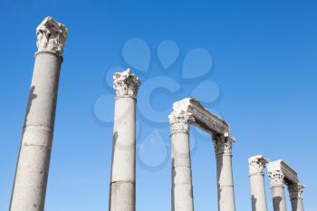 Ancient columns in a row on blue sky background, fragment of ruined roman temple in Smyrna. Izmir, Turkey