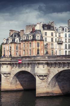 Pont Neuf. The oldest bridge across the Seine river in Paris, France. Vertical vintage toned photo filter