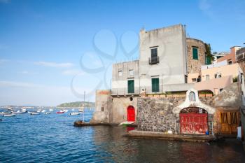 Coastal landscape of Ischia Porto with old living houses on the coast