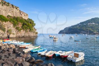 Coastal landscape of Ischia port with Aragonese Castle and colorful boats