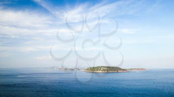 Mediterranean sea landscape with Procida island under cloudy sky, view from Ischia Ponte 