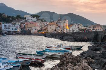 Ischia, Italy - August 15, 2015: Cityscape with boats of Ischia Porto at sunset, Mediterranean Sea coast