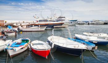 Fishing and pleasure boats and yachts moored in Lacco Ameno marina, Ischia island, Italy