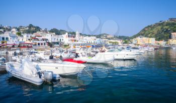 Pleasure boats and yachts moored in Lacco Ameno port, Ischia island, Italy