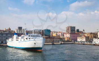 Port of Naples, coastal cityscape with white passenger ferry 