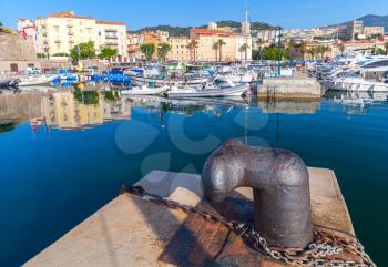 Big rusted mooring bollard in old port of Ajaccio, Corsica, France
