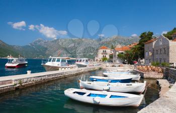 White fishing boats float moored in Perast. Kotor Bay, Montenegro