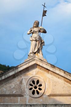 Jesus statue on the rooftop of ancient church in Perast, Montenegro