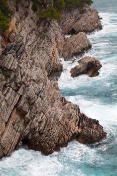 Coastal rocks with small pine trees growing on it. Adriatic Sea, Montenegro