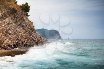 Breaking waves on stone Adriatic Sea coast in Montenegro