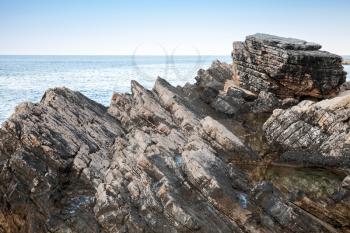 Dark rocks of Adriatic Sea coast. Montenegro