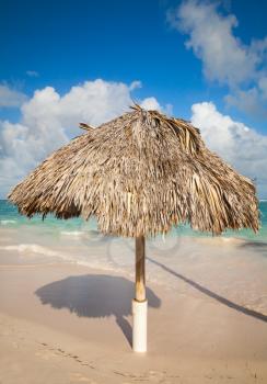 Wooden umbrella on the sandy beach in Dominican republic 