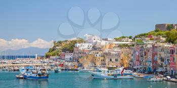 Small coastal Italian town cityscape with colorful houses. Port of Procida island, Gulf of Naples, Italy