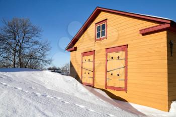 Rural yellow wooden house in winter season with snowdrifts. Suomenlinna, Helsinki, Finland