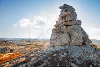 Stone cairn as a navigation mark on the top of Norwegian mountain