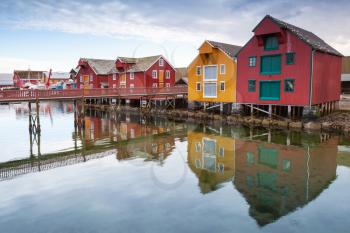 Red and yellow wooden houses in coastal Norwegian fishing village
