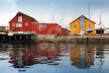 Red and yellow wooden coastal houses in Norwegian fishing village