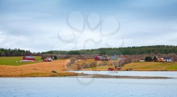 Traditional small Norwegian village with red wooden houses on rocky coast