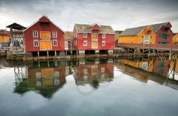 Red and yellow wooden houses in Norwegian fishing village. Rorvik, Norway