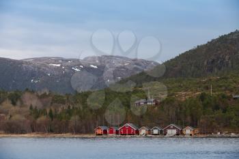 Traditional Norwegian small fishing village with colorful wooden houses on seacoast