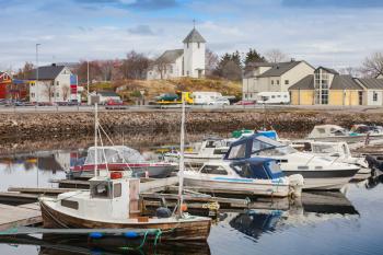 Norwegian fishing village landscape. Small boats are moored in marina