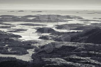 Monochrome Norwegian coastal landscape with sea and small islands in fjord