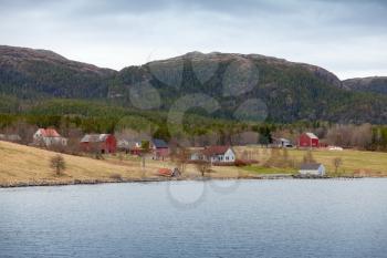 Traditional Norwegian small village, wooden houses and barns on seacoast
