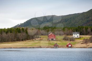 Traditional Norwegian small village, colorful wooden houses and barns on seacoast