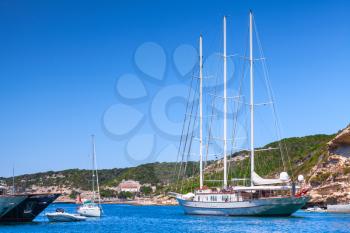 Sailing ship leaves the port of Bonifacio, Corsica island in sunny summer day, Corse-du-Sud, France