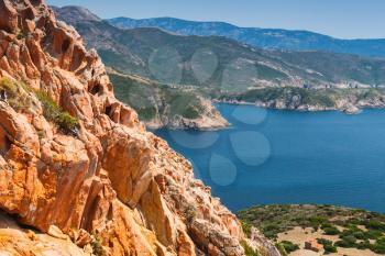 Coastal landscape of Corsica island with red rocks and blue sea water. Viewpoint of Capo Rosso, Piana region