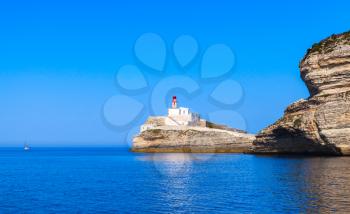 Madonetta, lighthouse tower with red top. Entrance to Bonifacio port. Mountainous Mediterranean island Corsica, Corse-du-Sud, France