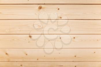 New wooden wall made of pine tree planks. Frontal flat background photo texture
