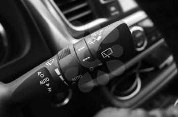 Multi functional wipers mode selector, modern car interior details. Close up photo with selective focus