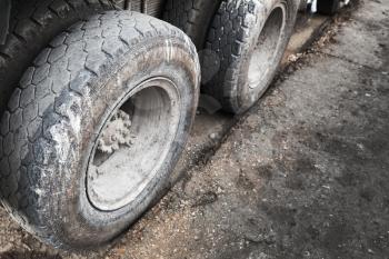 Cargo truck wheels on dirty asphalt road