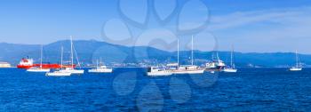 Sailing yachts and pleasure motorboats moored in bay of Ajaccio, Corsica, France. Panoramic photo