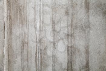 Old concrete wall with wet stains, grungy frontal background photo texture