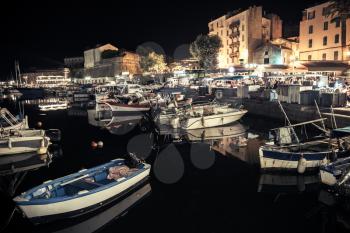 Pleasure and fishing boats moored in old port of Ajaccio, the capital of Corsica island, France. Night photo with tonal correction filter