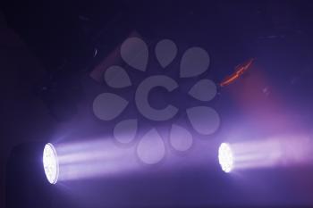 Purple spot lights with strong beams in smoke, stage illumination background photo