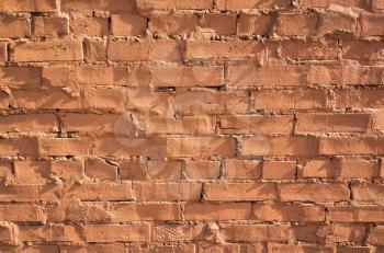 Grungy red brick wall, close-up background photo texture