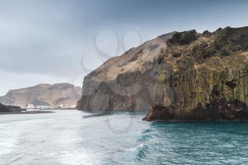 Coastal rocks of Vestmannaeyjar island, Iceland. Entrance to port