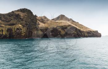 Natural landscape with coastal rocks of Vestmannaeyjar island, Iceland