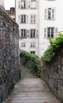 Old town of Geneva, Switzerland. Vertical street view with stone stairway and living houses