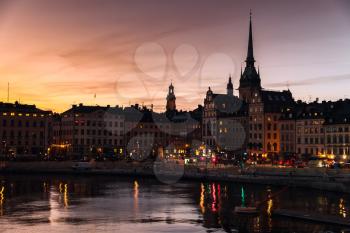 Silhouette cityscape of Gamla Stan city district, central Stockholm with German Church spire over colorful sky
