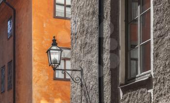 Old house facade with street lamp. Gamla stan, the old town in central Stockholm, Sweden